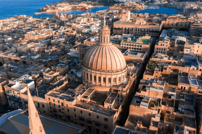 Valletta at sunset with the Carmelite basilica dome and St Paul's Pro-Cathedral spire