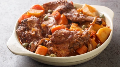 Stuffat tal-fenek, traditional Maltese rabbit stew, in a pan