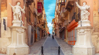 Stepped Maltese street with statues of saints on the house corners