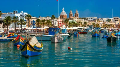 Colourful luzzu fishing boats with painted eyes in Marsaxlokk harbour