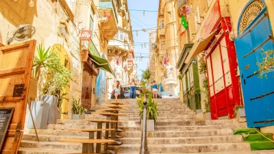 Sunny street with colourful balconies in Valletta